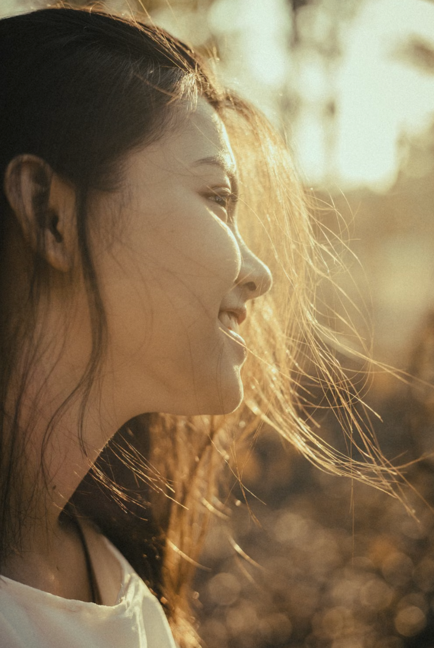 Woman with natural, unretouched skin in soft window light
